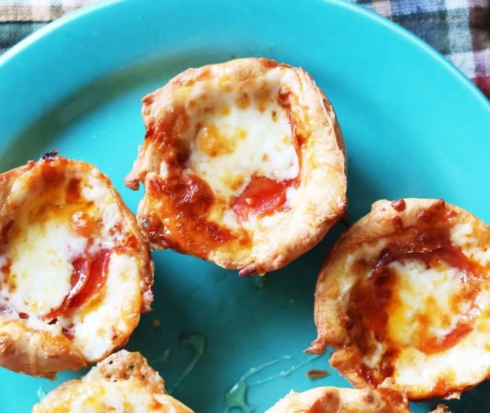 Hot honey pizza muffins: Pepperoni, cheese, layered in a muffin tin drizzled with hot honey.