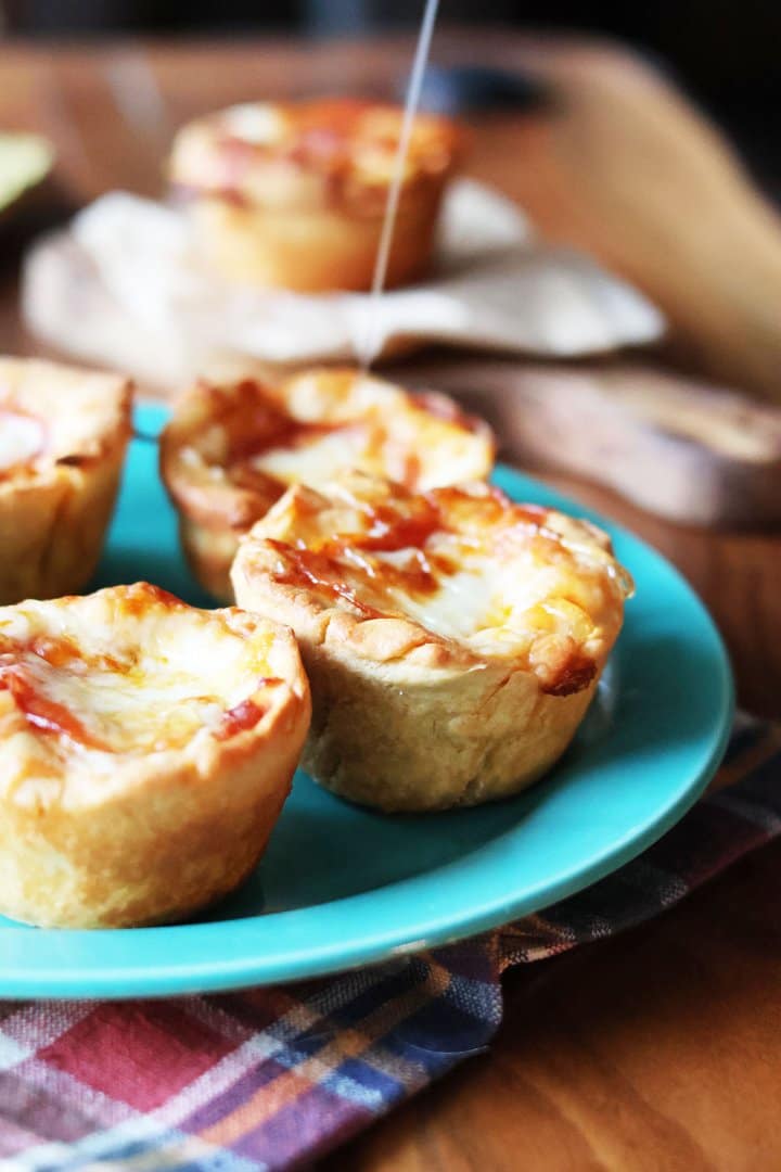 Muffin pizzas, drizzled with hot honey. Click through for recipe.