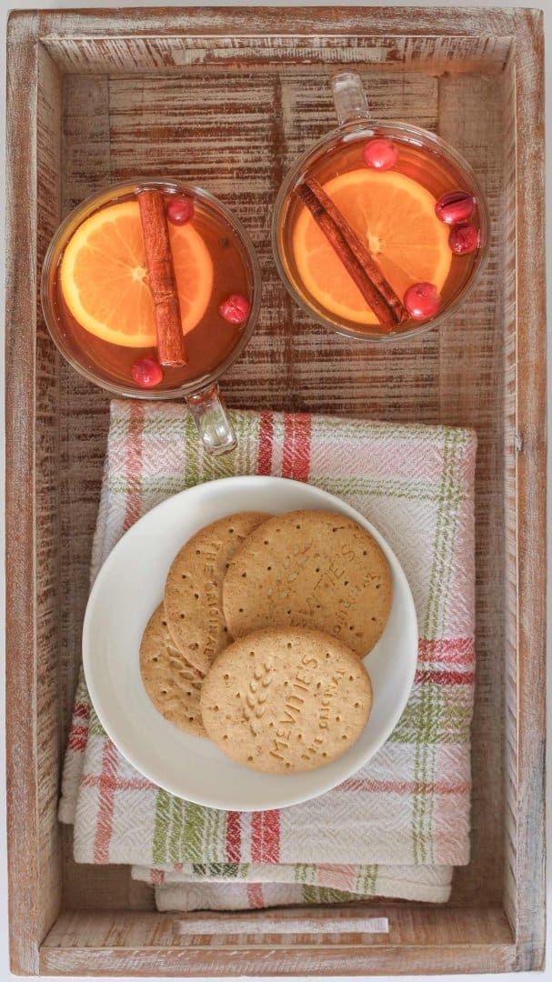 cups of christmas punch on a tray with a festive napkin and plate of cookies.